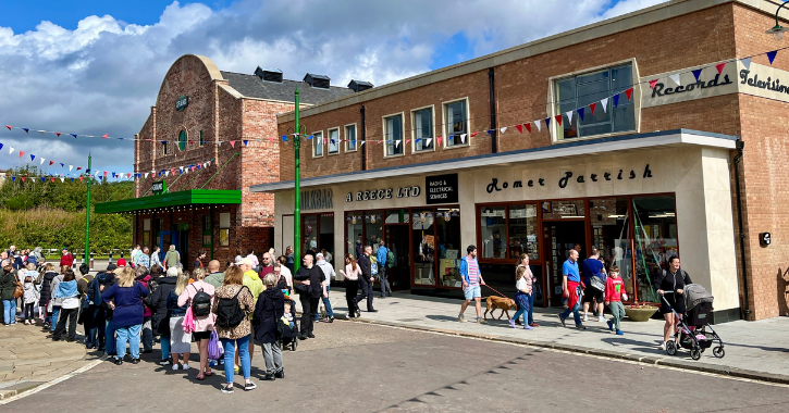 View of the 1950s town main street with different shops and cinema at Beamish Museum.